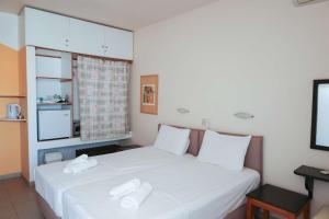 a bedroom with a bed with two white towels on it at Al Mar 2 in Skiathos