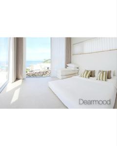 a bedroom with a bed with a view of the ocean at Pohang Poolvilla Dearmood in Pohang