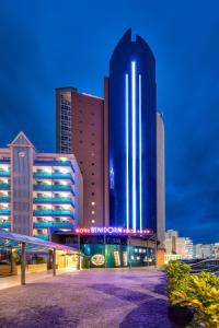 a tall blue building with a sign in front of it at Benidorm Plaza in Benidorm