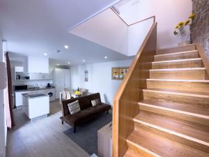 a room with a staircase and a living room at Casa das Flores in Oliveira do Hospital