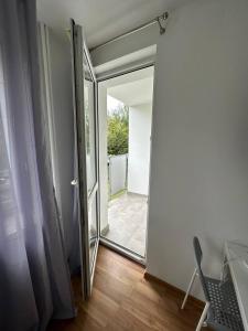 an open door to a room with a sliding glass door at Anielewicza 26 Rooms in Warsaw