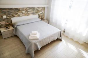 una camera da letto con un letto e due asciugamani di Residence Deamarina a Marina di Massa