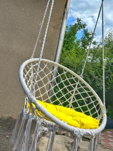 a rope swing with a yellow cushion on it at Guest House in Sevan