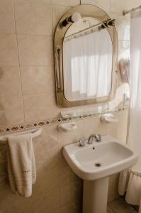 a bathroom with a sink and a mirror at Altezza Apart Suites in Mendoza