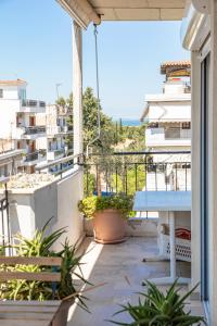 einen Balkon mit einem Tisch und Meerblick in der Unterkunft Houseloft Kalamaria Highview in Thessaloniki