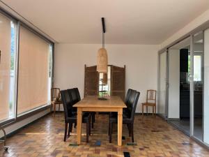 a dining room with a wooden table and chairs at Minusio-Locarno Casa al Lago 2 in Minusio