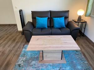a living room with a couch and a coffee table at River Lilly Apartment in Obertraun