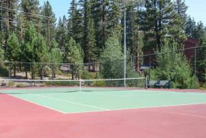 a tennis court with a net and a bench at Mammoth Ski & Racquet Club #28, New 2023 Remodel! Walk to Canyon Lodge Lifts in Mammoth Lakes