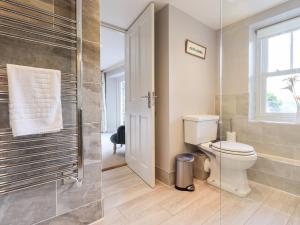 a bathroom with a toilet and a glass shower at Fair Rigg in Sawrey