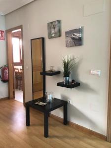 a room with a table and shelves on the wall at Casa Mariva in Arriondas