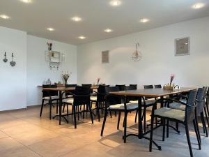 een eetkamer met houten tafels en stoelen bij Berghof Erlebnis AG in Pfaffnau
