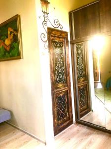 an empty room with a door and a mirror at Batumi Wonderland Guest House in Batumi