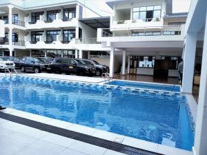 a large swimming pool in front of a building at Virunga Hotel in Ruhengeri