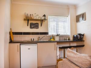 a kitchen with a sink and a counter at Roxys Cottage - Uk44687 in Burnopfield