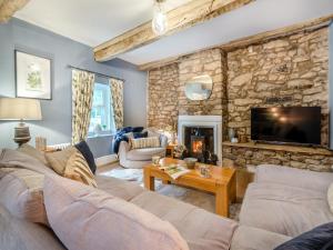 a living room with a stone wall at Low Fold - Uk44733 in Tallentire