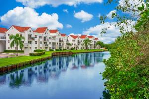 a row of apartment buildings next to a river at Comfy Apartments at Sheridan Ocean Club in Florida in Dania Beach