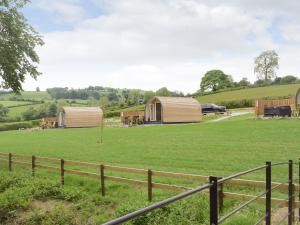 a field with two tents and a fence at Cain Pod Vip in Llanfyllin