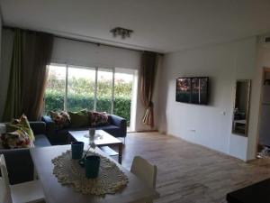 a living room with a couch and a table at Hébergement bord de mer in Casablanca