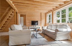 a living room with two couches and a tv at Pet Friendly Home In Kalundborg With Sauna in Kalundborg