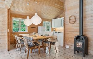 a kitchen and dining room with a wood stove at Beautiful Home In Kalundborg With Sauna in Kalundborg