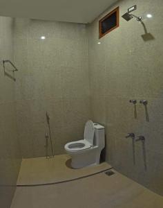 a bathroom with a toilet and a shower at Sivakumar Paradise in Mahabalipuram