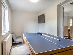 a ping pong table in the middle of a room at Baythorn End in Antingham