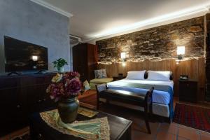 a hotel room with a bed and a couch and a table at Εσπερίδες in Naousa Imathias +54 photos