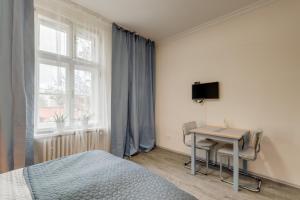Televízia a/alebo spoločenská miestnosť v ubytovaní Vita Nejedleho apartments