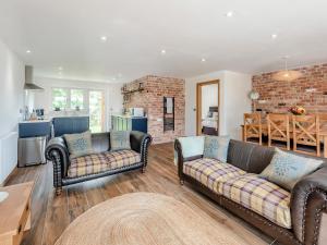 a living room with two couches and a kitchen at Herons Den - Uk44529 in Horncastle