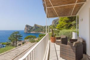 a house with a balcony with a view of the ocean at Villa Rita Apartments in Massa Lubrense