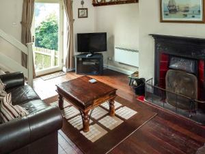a living room with a couch and a coffee table at Seagull Cottage in Whitby