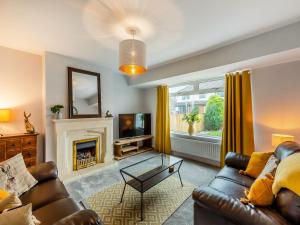 a living room with a couch and a fireplace at Castle View House in Amble