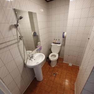 a bathroom with a toilet and a sink at Seven Hostel in Seoul