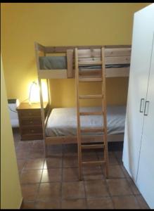 a bunk bed with a ladder in a room at Casetta Santa Maria in Subiaco