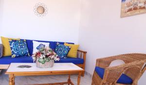 a living room with a blue couch and a table at Vivienda Miramar in Mazo