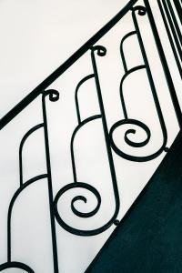 a black and white wrought iron railing at Hotel Flanelles Paris in Paris