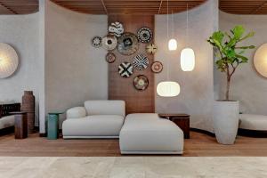 a living room with a chair and plates on the wall at GRANO HOTEL Solmarina in Wiślinka