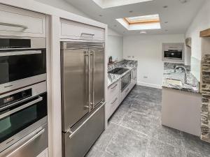 a kitchen with stainless steel appliances and marble floors at Victoria House in Chulmleigh