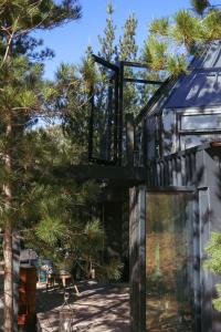 a glass house with trees in the background at The Franschhoek Glass Teepee #OnceUponaDome in Franschhoek