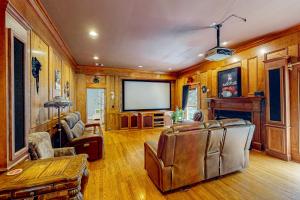 a living room with a couch and a television at Fresh Getaway in Fayetteville