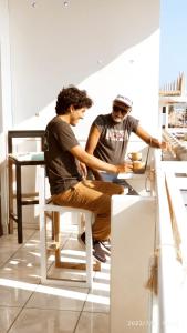 two men sitting at a table in a room at ArenaNorte in Pimentel