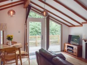 a living room with a couch and a table at Woodlands Lodge in Colmonell