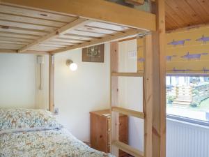 ein Schlafzimmer mit einem Etagenbett mit einer Leiter neben einem Fenster in der Unterkunft Woodlands Lodge in Colmonell