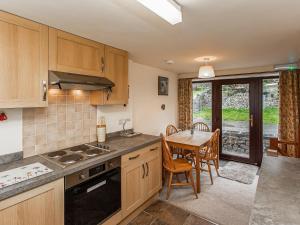 a kitchen with a table and a dining room at Jerusalem Cottage in Longnor