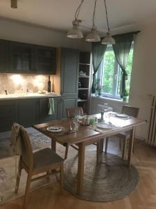 布拉格的住宿－Lovely And Freshly Renovated Apartment In Praha 10，一间带木桌和椅子的厨房以及一间用餐室