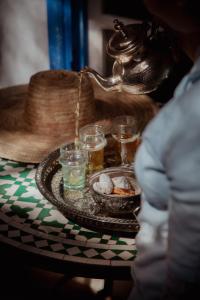 a table with a tray of food and drinks on it at Villa Maroc Essaouira in Essaouira