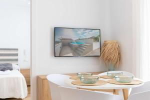 a living room with a table with bowls on it at APARTAMENTOS CARMEN in Maro