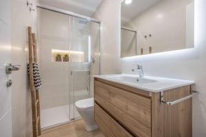 a bathroom with a sink and a toilet and a shower at APARTAMENTOS CARMEN in Maro
