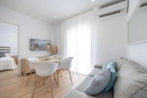 a living room with a couch and a table at APARTAMENTOS CARMEN in Maro