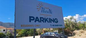 a sign that says parking in front of a car at Grand TheoNi Boutique Hotel & Spa in Vasiliki